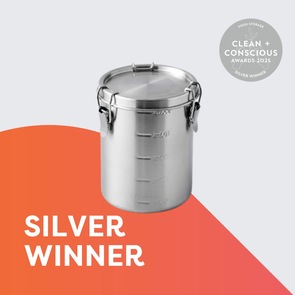 Stainless steel round food storage container with a secure clip-lock lid displayed on a light grey background. A Clean + Conscious Awards 2025 Silver Winner badge appears in the top right, with bold text at the bottom reading: "SILVER WINNER."