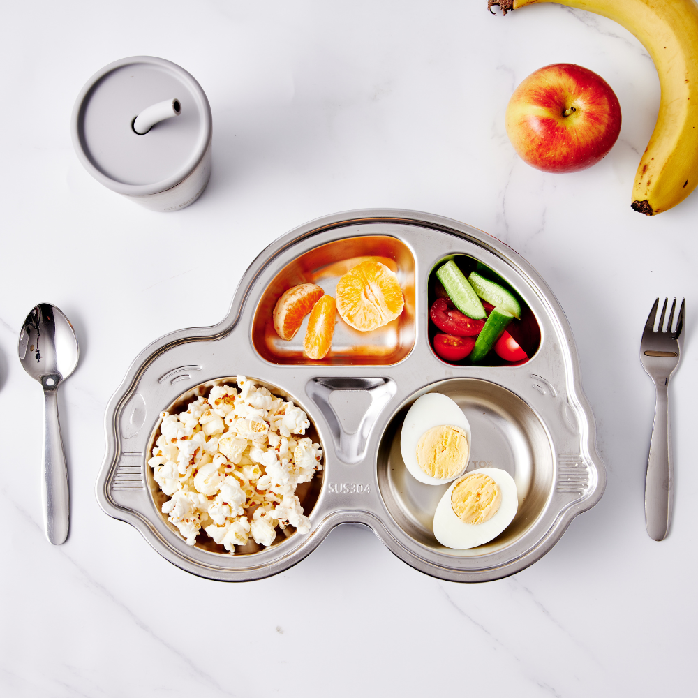 Stainless steel divided car plate with suction, featuring sections for popcorn, fruits, and vegetables on a marble surface.
