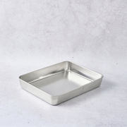 Stainless steel slice tray with polished finish displayed on a light grey background.