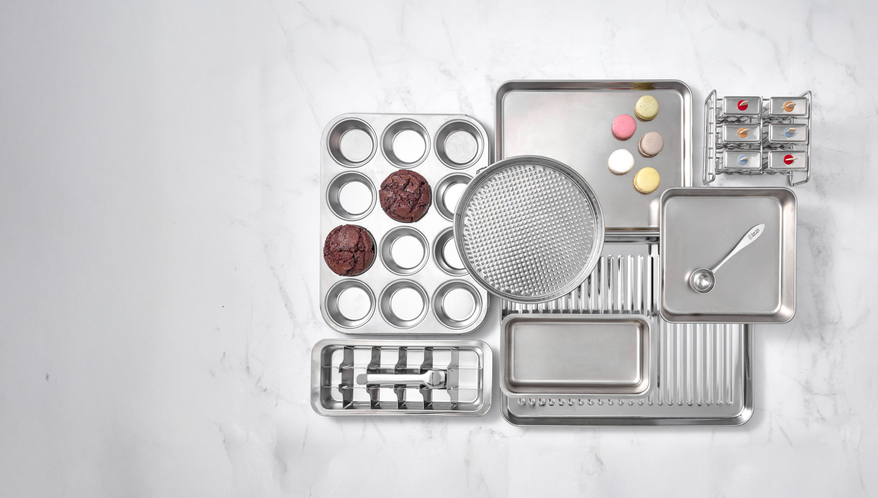 A collection of The Low Tox Project stainless steel products on a neutral background.
